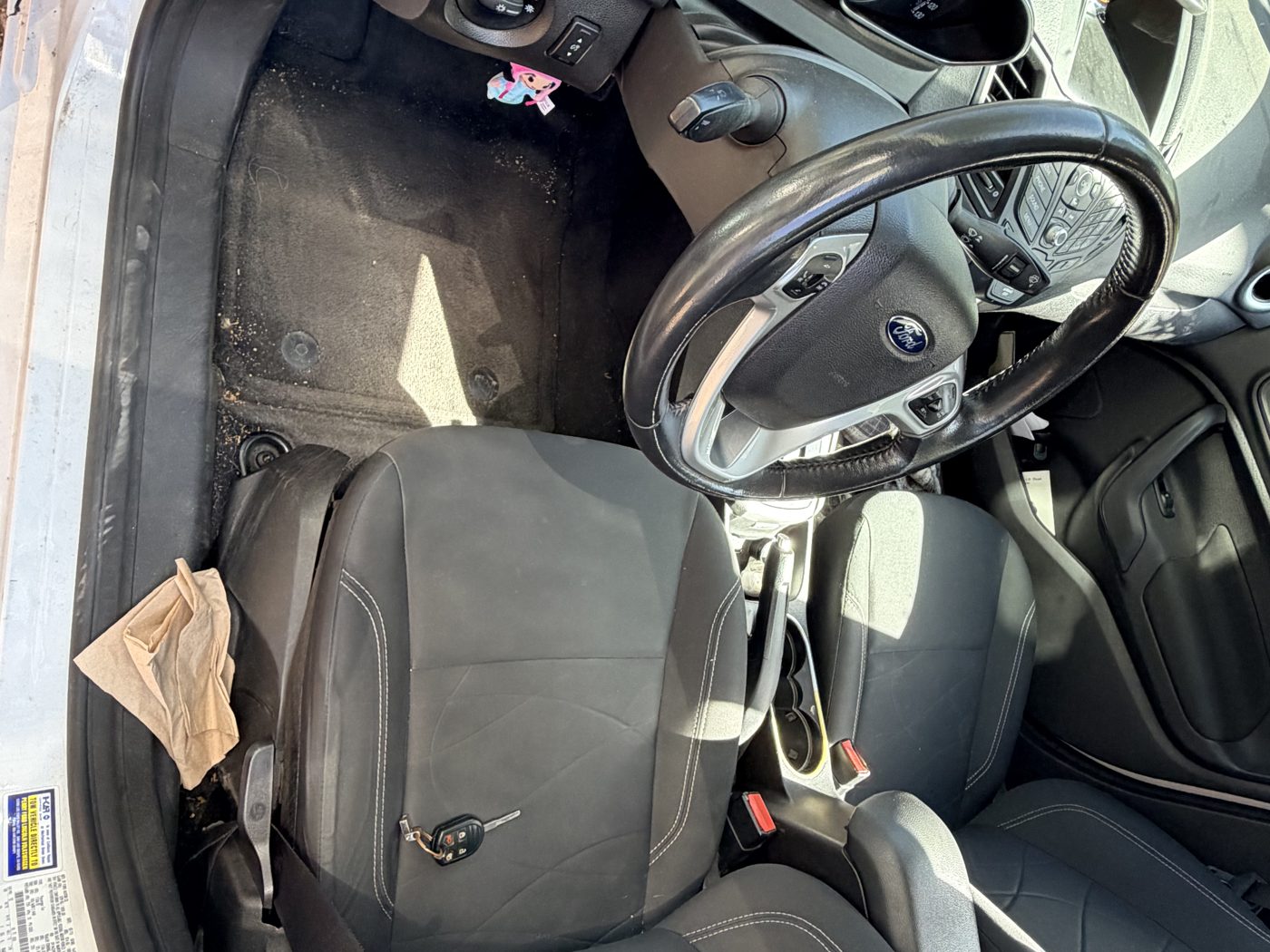Sedan interior before detailing, dusty and cluttered