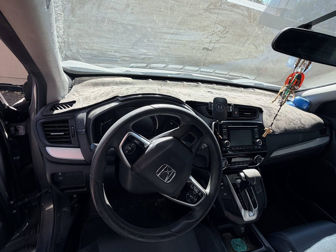 SUV interior before detailing, dusty dashboard